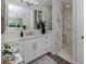 Elegant bathroom with a walk-in shower and white vanity at 507 Tamiami N Trl # 201, Venice, FL 34285