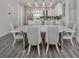 Modern dining area with gray chairs and white table at 507 Tamiami N Trl # 201, Venice, FL 34285