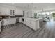 Open concept kitchen with stainless steel appliances and white cabinetry at 507 Tamiami N Trl # 201, Venice, FL 34285