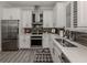 Modern kitchen featuring stainless steel appliances and white shaker cabinets at 507 Tamiami N Trl # 201, Venice, FL 34285
