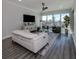 Spacious living room with a white couch and water views at 507 Tamiami N Trl # 201, Venice, FL 34285