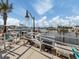 Relaxing waterfront patio with boats and palm trees at 507 Tamiami N Trl # 201, Venice, FL 34285