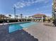 Community pool with a tiled patio and lounge chairs at 507 Tamiami N Trl # 201, Venice, FL 34285