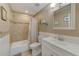 Clean bathroom with tub shower, updated vanity, and neutral tile at 5116 Beach Se Dr # D, St Petersburg, FL 33705