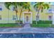 Building entrance with lush landscaping and palm trees at 5116 Beach Se Dr # D, St Petersburg, FL 33705