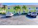 Light yellow building exterior with parking and palm trees at 5116 Beach Se Dr # D, St Petersburg, FL 33705