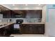 Modern kitchen with dark wood cabinets and granite countertops at 5116 Beach Se Dr # D, St Petersburg, FL 33705