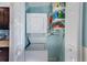 Compact laundry closet with stacked washer and dryer at 5116 Beach Se Dr # D, St Petersburg, FL 33705
