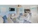 Bright living room with two sofas and a large TV at 5116 Beach Se Dr # D, St Petersburg, FL 33705