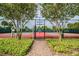 Two lighted tennis courts with brick pathway at 5116 Beach Se Dr # D, St Petersburg, FL 33705