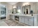 Elegant bathroom with double vanity, large mirror, and walk-in shower at 5327 Kelper Hook Ct, Wimauma, FL 33598