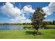 Serene lake view with lush greenery and a beautiful homesite at 5548 Sentiero Dr, Nokomis, FL 34275