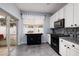 Kitchen with white cabinets, black appliances, and a view to backyard at 582 Vallance Ne Way, St Petersburg, FL 33716