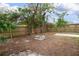 Fenced backyard offering a large grassy area with mature trees at 6350 22Nd N Ave, St Petersburg, FL 33710