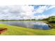 Serene lake view with lush green grass at 6519 Grand Estuary Trl # 105, Bradenton, FL 34212