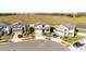 Aerial view of a new neighborhood with houses and green spaces at 7815 Bronze Oak Dr, Wesley Chapel, FL 33545