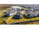 Aerial view of houses near a lake, showcasing backyards at 7815 Bronze Oak Dr, Wesley Chapel, FL 33545