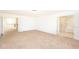 Large bedroom with carpeting, ensuite bathroom access, and loft view at 7815 Bronze Oak Dr, Wesley Chapel, FL 33545