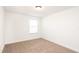 Well-lit bedroom with neutral carpeting and window at 7815 Bronze Oak Dr, Wesley Chapel, FL 33545
