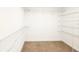 Large walk-in closet with wire shelving and neutral carpeting at 7815 Bronze Oak Dr, Wesley Chapel, FL 33545