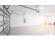 Garage with open door, white walls, and epoxy flooring at 7815 Bronze Oak Dr, Wesley Chapel, FL 33545