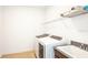 Laundry room with washer, dryer, and utility sink at 7815 Bronze Oak Dr, Wesley Chapel, FL 33545