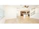 Bright and airy living room with tile flooring and access to kitchen at 7815 Bronze Oak Dr, Wesley Chapel, FL 33545