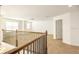 Spacious loft area with wood railing and carpet flooring at 7815 Bronze Oak Dr, Wesley Chapel, FL 33545