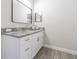 Bathroom with white vanity, granite countertop and frameless mirror at 8510 Dee Cir, Riverview, FL 33569