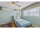 Light green bedroom with hardwood floors and window blinds at 8716 Hickorywood Ln, Tampa, FL 33615