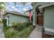 Welcoming front entrance with a brown door and American flag at 9044 Westbay Blvd, Tampa, FL 33615