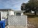 Rear of the home featuring a block wall and satellite dish at 1002 N Pebble Beach Blvd # 1002, Sun City Center, FL 33573