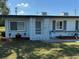 Charming single-story home with decorative white privacy screen and well-maintained front yard at 1002 N Pebble Beach Blvd # 1002, Sun City Center, FL 33573