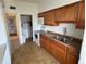 Well-lit kitchen with stainless steel sink, wood cabinets, and modern appliances at 1002 N Pebble Beach Blvd # 1002, Sun City Center, FL 33573