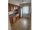 Cozy kitchen featuring wood cabinets and tile floors at 1002 N Pebble Beach Blvd # 1002, Sun City Center, FL 33573