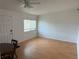 Simple living room with laminate floors and a ceiling fan at 1002 N Pebble Beach Blvd # 1002, Sun City Center, FL 33573