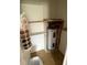 Compact utility closet with a water heater, shelving, and laundry area at 1002 N Pebble Beach Blvd # 1002, Sun City Center, FL 33573
