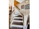 Modern staircase with dark wood steps and white risers at 11536 Crowned Sparrow Ln, Tampa, FL 33626