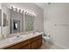 Main bathroom with double sinks and a shower/tub combo at 11919 Northumberland Dr, Tampa, FL 33626