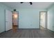 Bedroom with light green walls, wood-look flooring, and access to bathroom at 1205 Chevy Chase Dr, Sun City Center, FL 33573