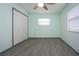 Bedroom with light green walls and double closets at 1205 Chevy Chase Dr, Sun City Center, FL 33573