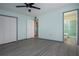 Bedroom with light green walls, wood-look flooring, and bathroom access at 1205 Chevy Chase Dr, Sun City Center, FL 33573
