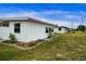 White single story home with landscaping and grassy yard at 1205 Chevy Chase Dr, Sun City Center, FL 33573