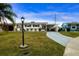 Ranch style home with carport, well-manicured lawn, and mature landscaping at 1205 Chevy Chase Dr, Sun City Center, FL 33573