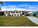 Ranch home with carport and a spacious front yard at 1205 Chevy Chase Dr, Sun City Center, FL 33573