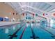 Indoor lap pool with multiple lanes and pool deck at 1205 Chevy Chase Dr, Sun City Center, FL 33573