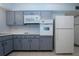 Kitchen with gray cabinets, built-in microwave, and oven at 1205 Chevy Chase Dr, Sun City Center, FL 33573