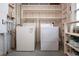 Bright laundry room with washer, dryer, and storage shelves at 1205 Chevy Chase Dr, Sun City Center, FL 33573