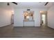 Living room with view to kitchen and wood-look floors at 1205 Chevy Chase Dr, Sun City Center, FL 33573