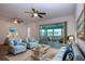 Bright and airy living room with comfy seating and access to a sunroom at 1205 Chevy Chase Dr, Sun City Center, FL 33573